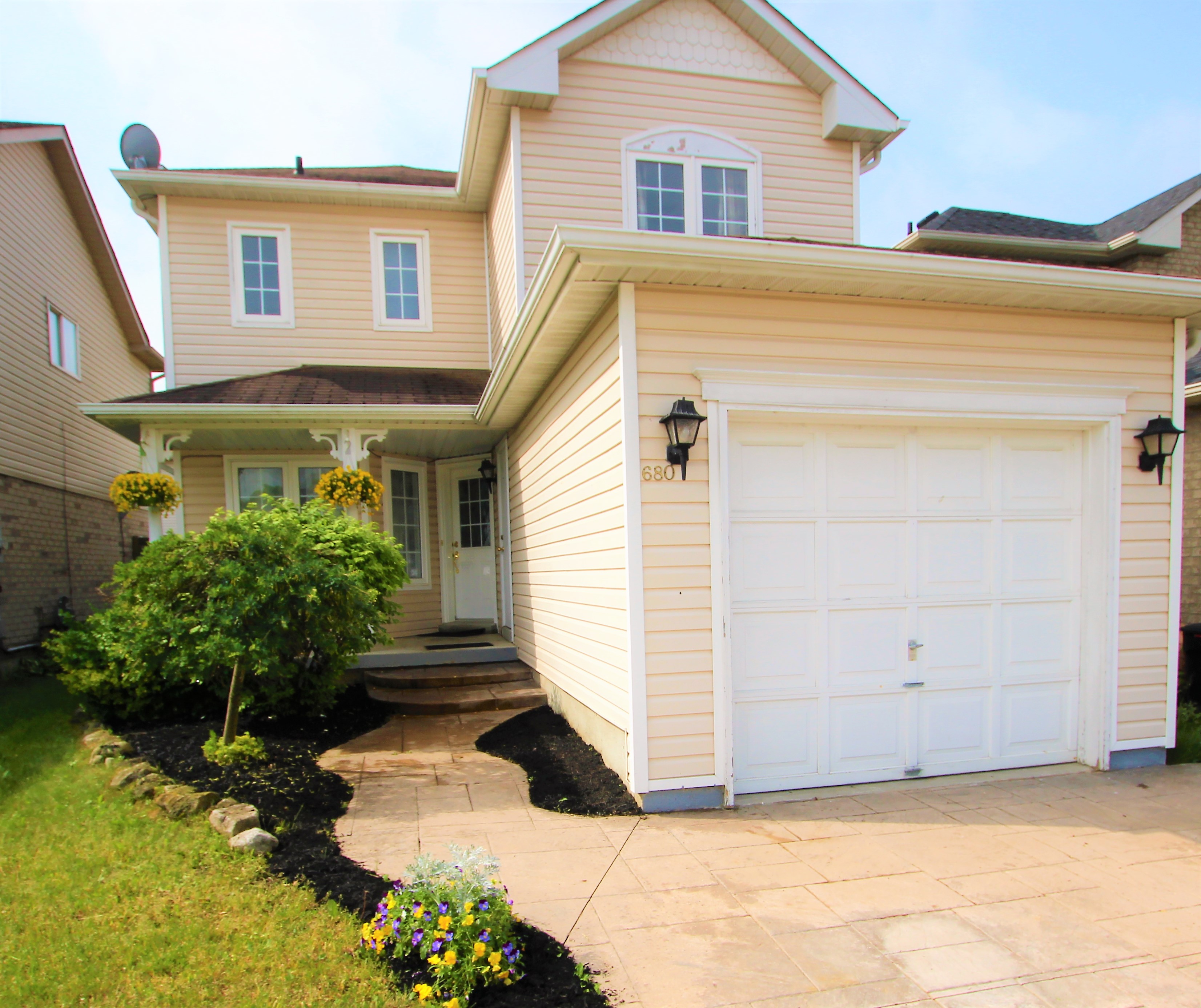 Front view of the house showing the parking gate and main door at 680 Langlaw Drive